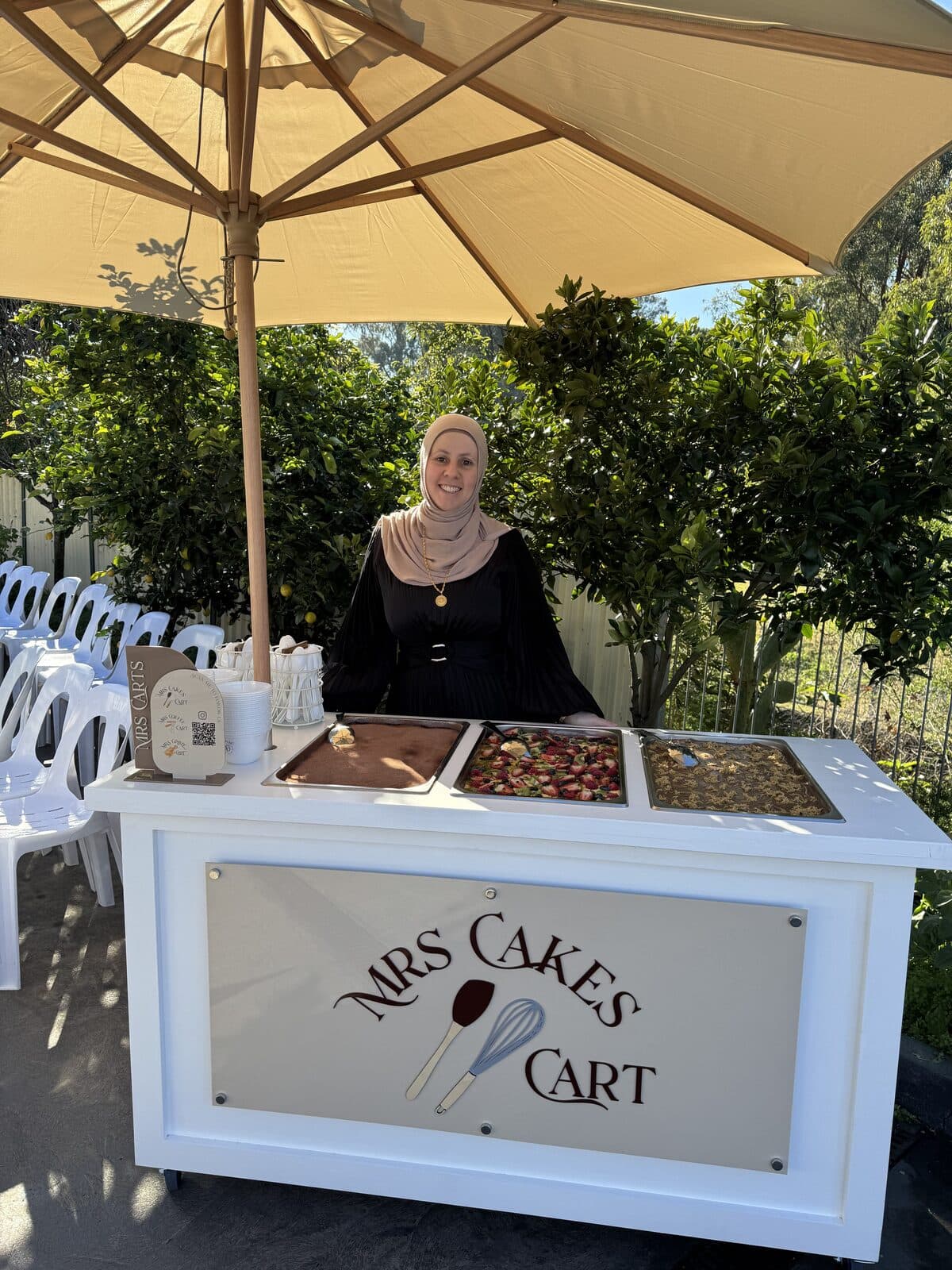 Sara serving from her branded cart at an outdoor event